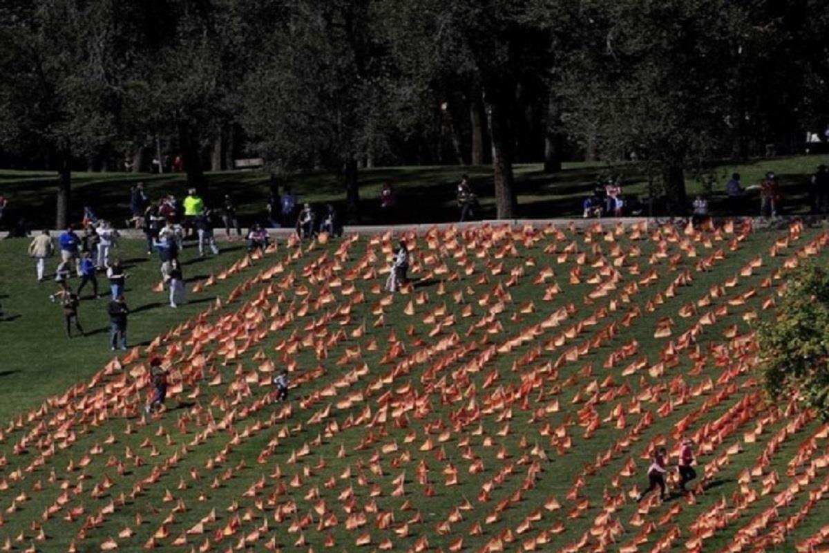 Grupos de personas colocan 53.000 banderas en el césped, una actuación ilegal ya que las reuniones superan el límite de seis personas